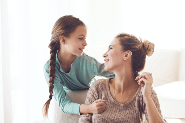 Mother and daughter smiling at each other